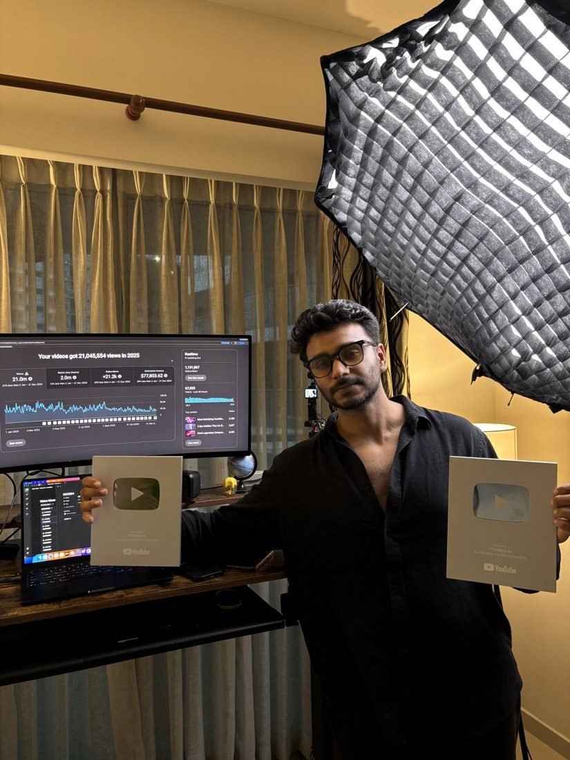 Abshar, founder of YTfacelessAgency, holding two YouTube play button awards